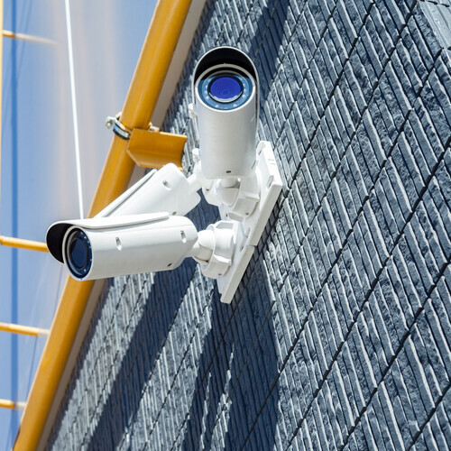 security cameras against a building wall