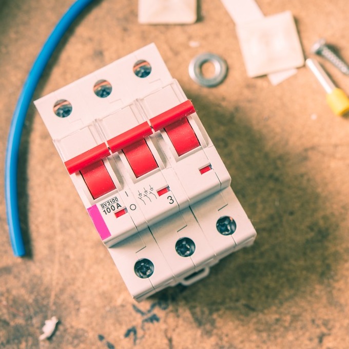 circuit breaker parts depicted with tools and other machinery parts.