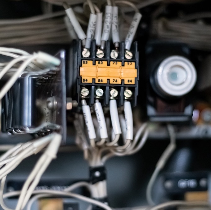 Electrical wirings on display with a control panel in the background