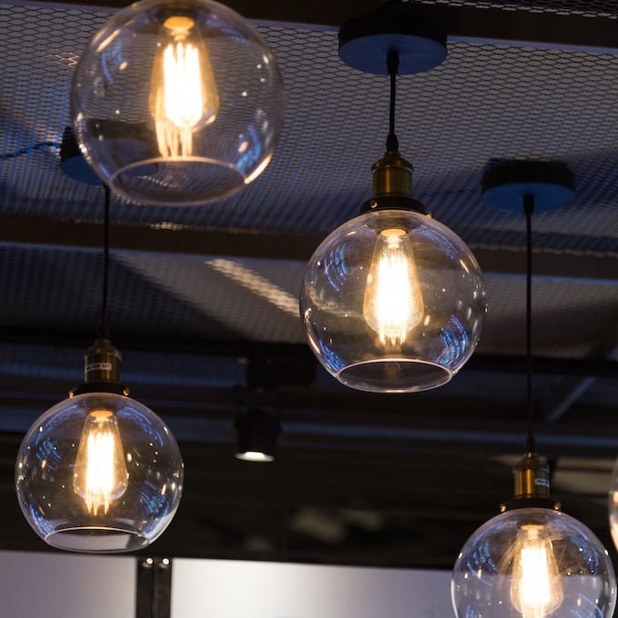 A large lighting installation in a kitchen with a tall ceiling.